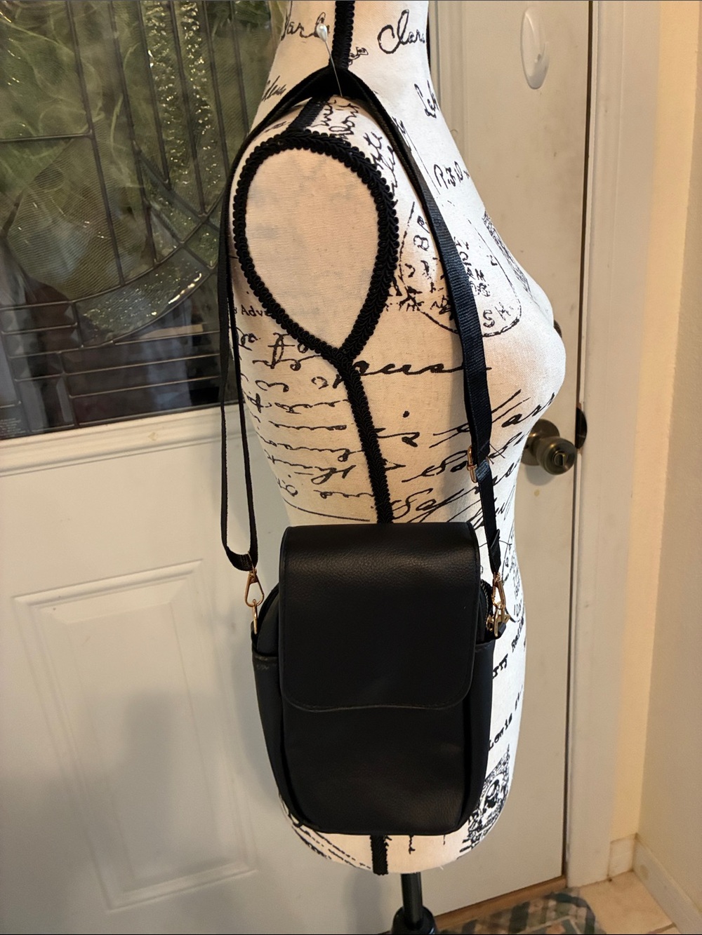 Sleek Black Crossbody Bag with Gold Accents